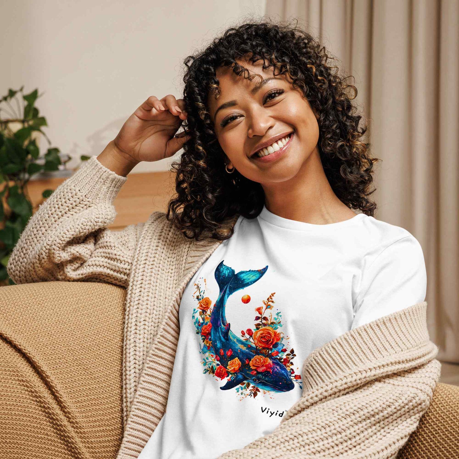 adult t-shirt collection cover image of an attractive curly hair black woman wearing a cute blue whale t-shirt sitting on the sofa in the living room